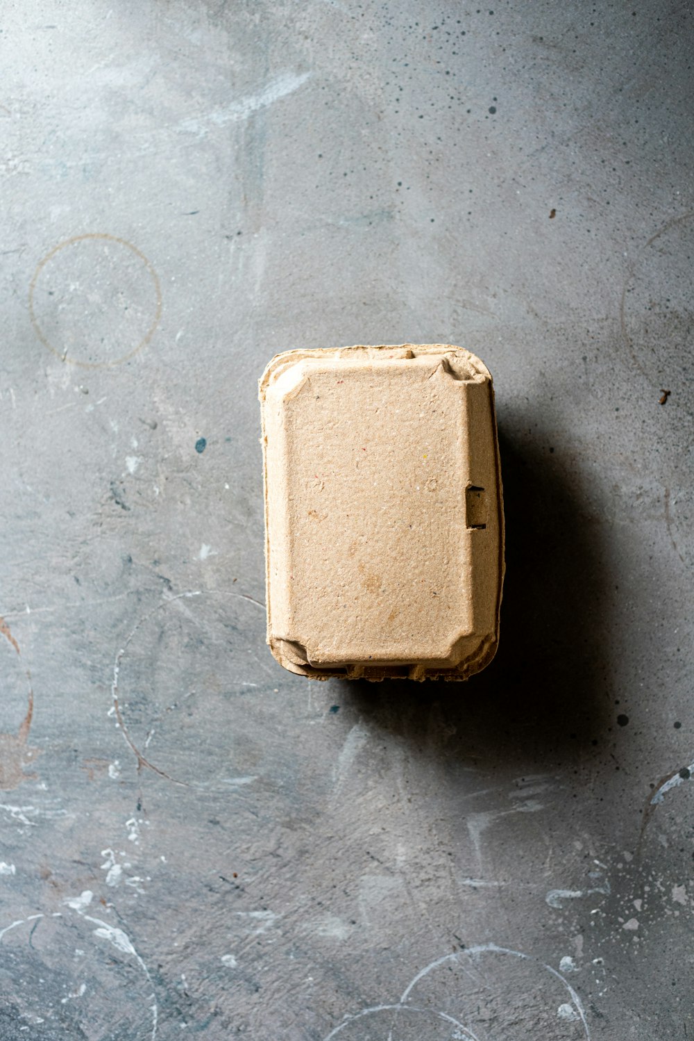 white plastic container on gray concrete floor