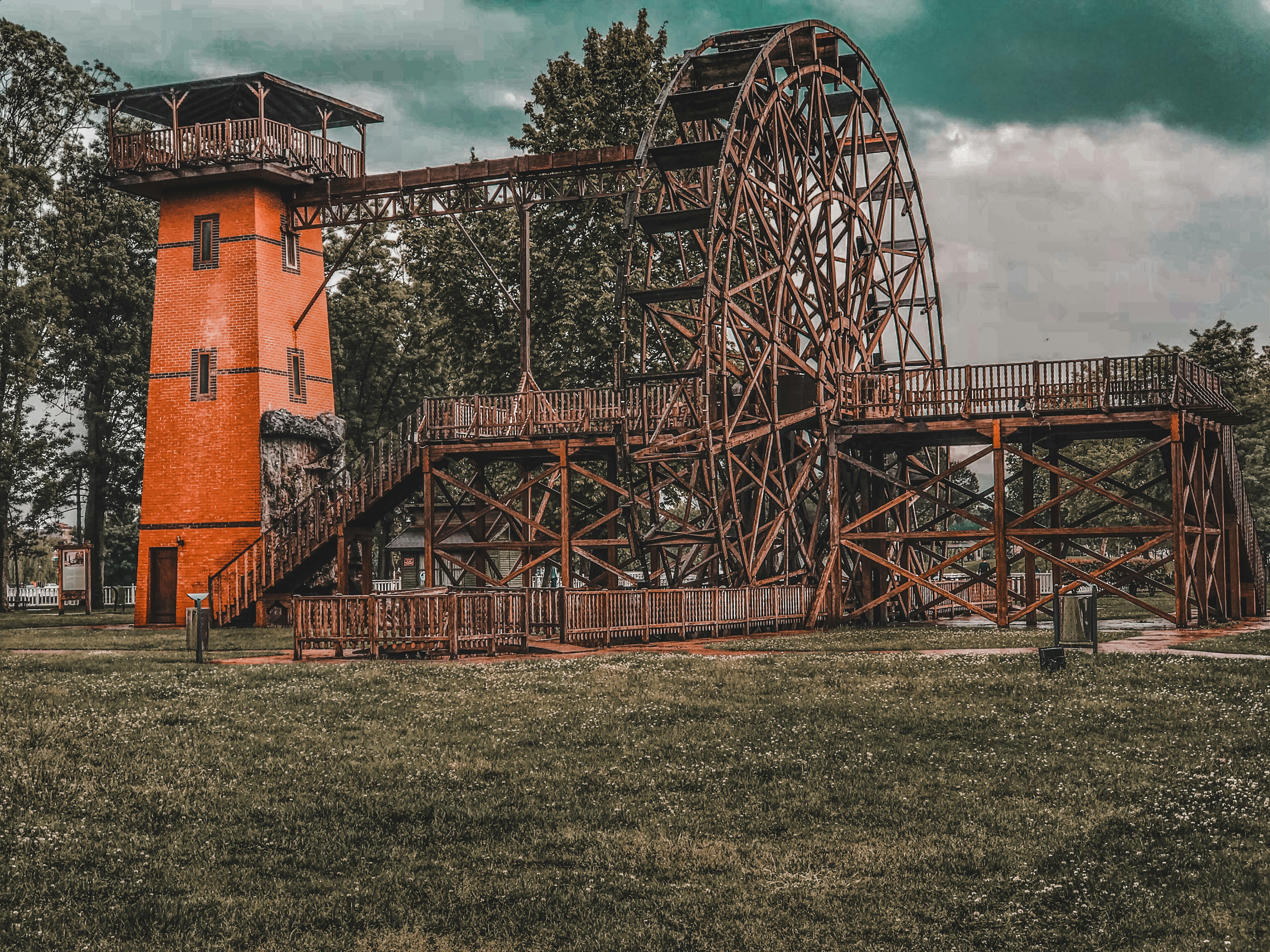 brown brick building near green grass field under blue sky during daytime