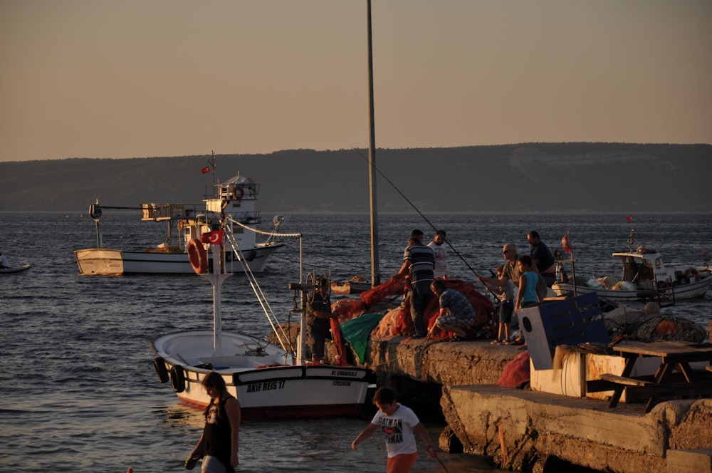 people riding on white boat during daytime