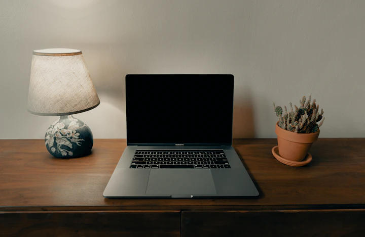 a laptop open on a wooden table