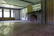 Before and after images showing a fire-damaged living room restored to pristine condition.