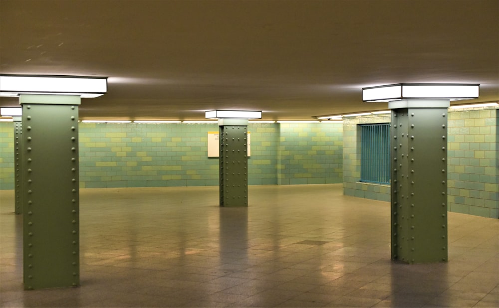 white and green hallway with white ceiling lights