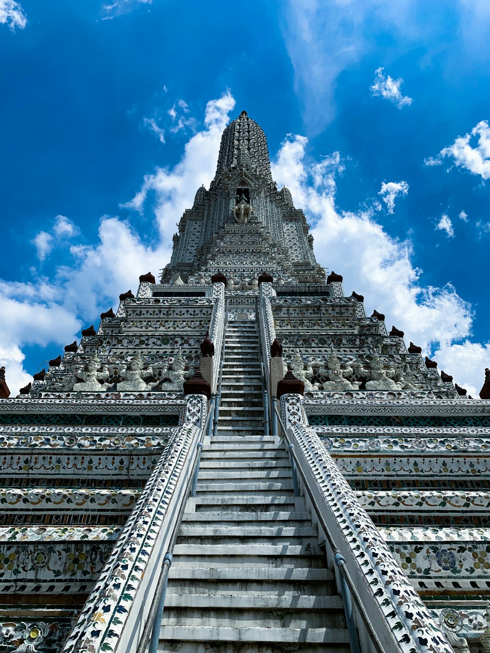 gold and white concrete tower under blue sky