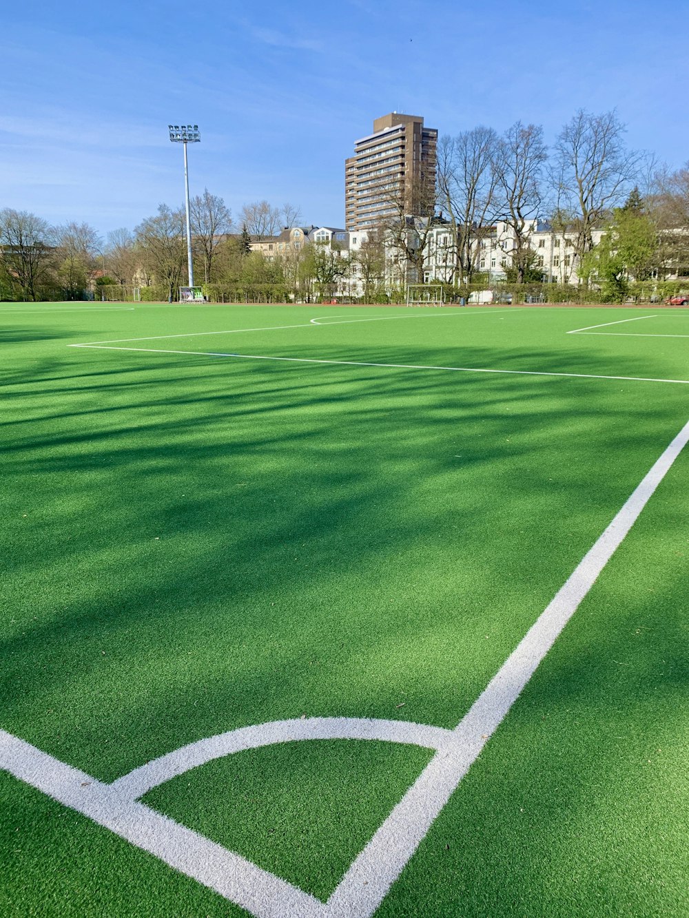 green grass field near brown building during daytime