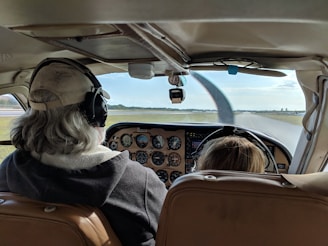 woman in black and white scarf sitting on brown leather car seat