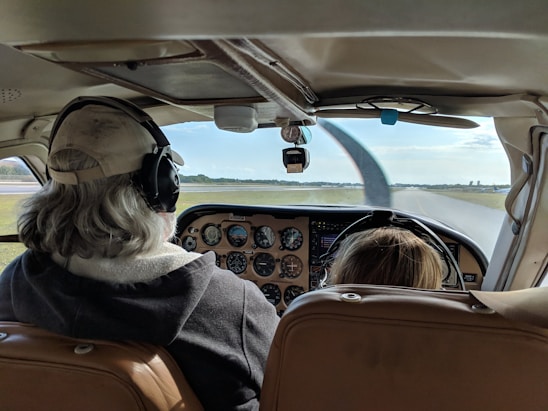 woman in black and white scarf sitting on brown leather car seat