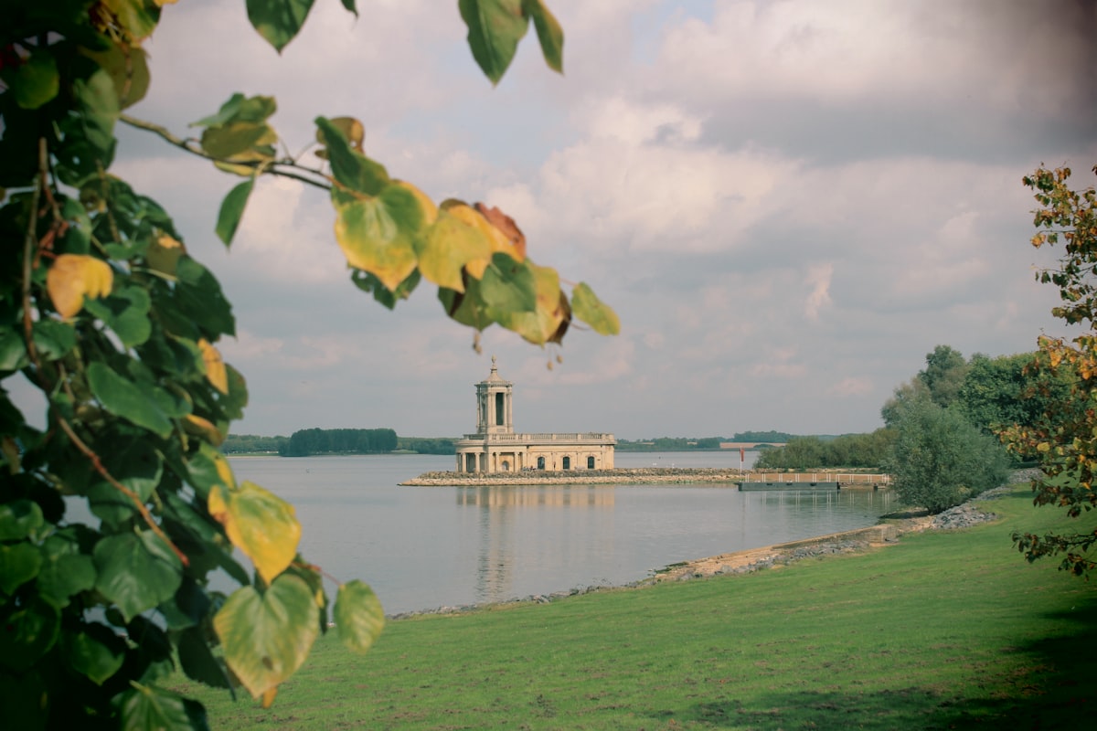 Rutland Water reservoir with green fields and cloudy sky near Oakham, Rutland