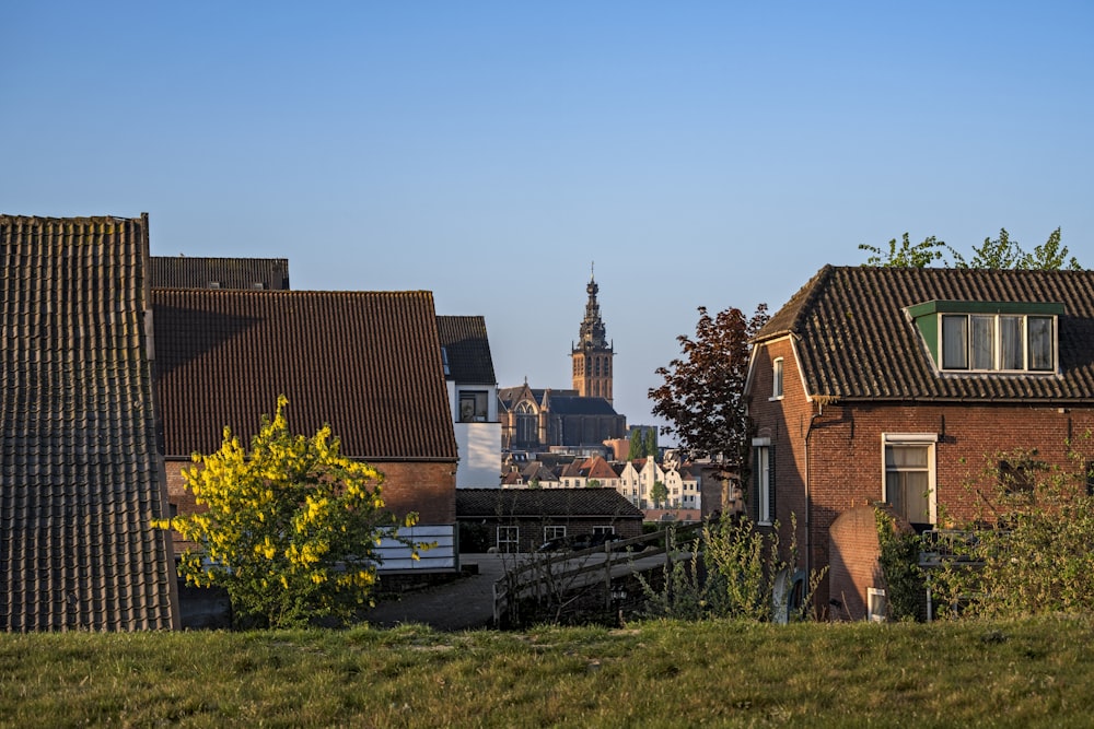 brown brick house near green grass field during daytime