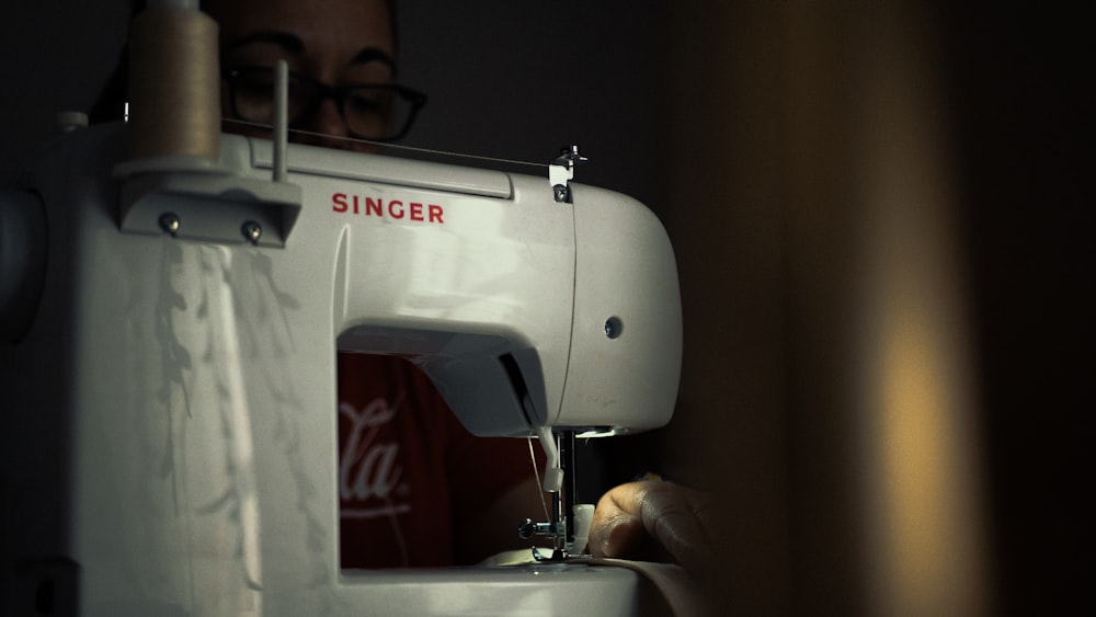 white sewing machine on table