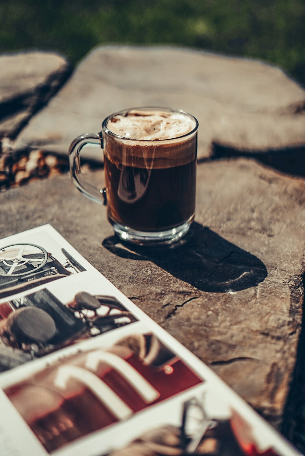 clear glass mug with brown liquid on brown wooden table