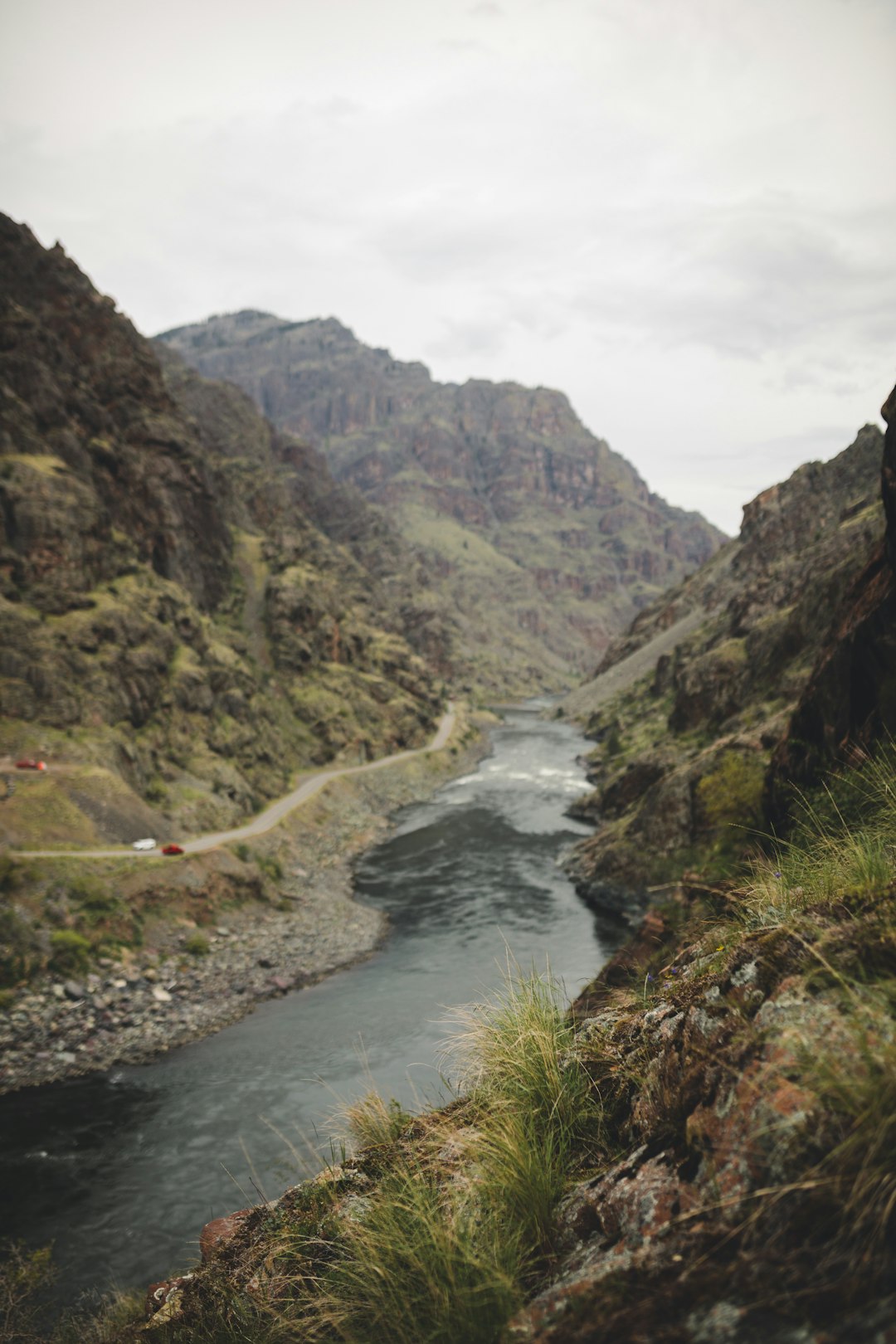 river between green mountains during daytime