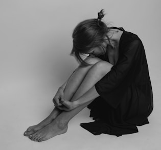 woman in black dress sitting on floor