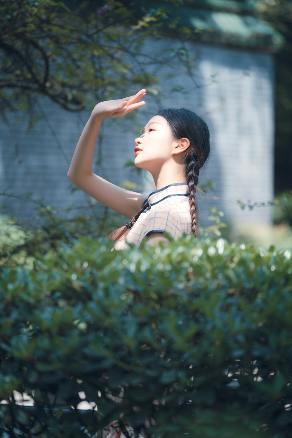 woman in white and black polka dot tank top standing on green grass field during daytime