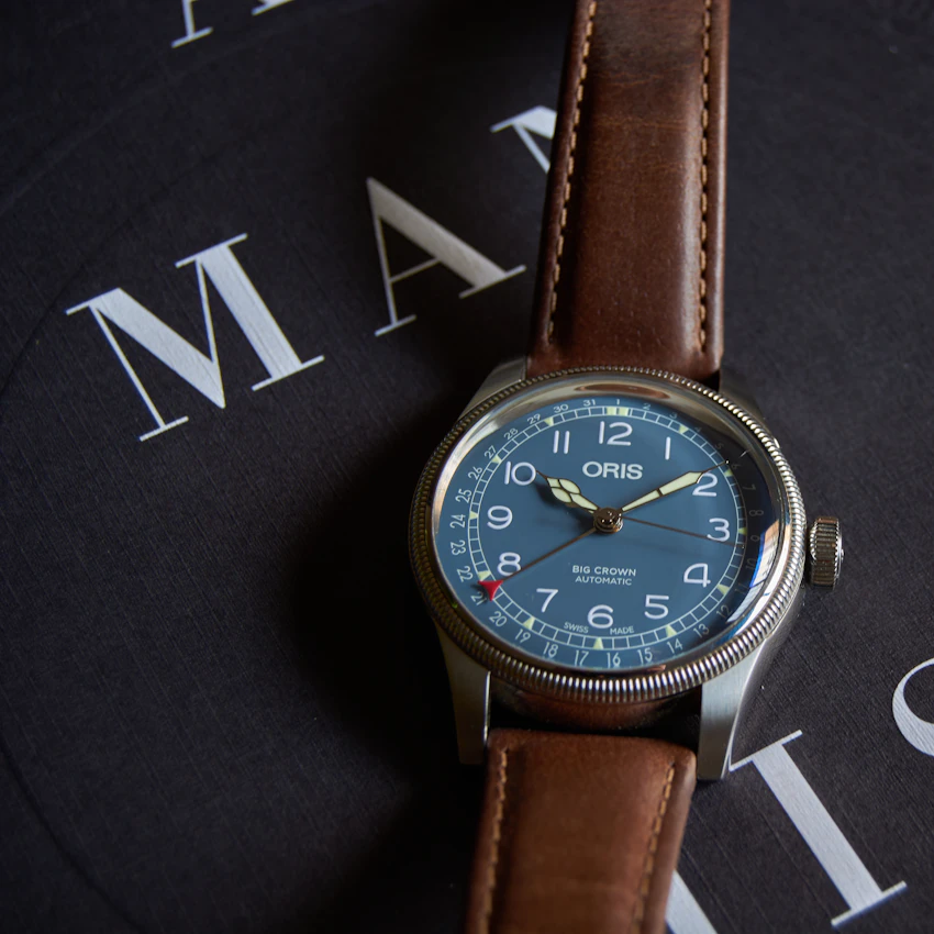 Pilot-style wristwatch on a brown leather strap