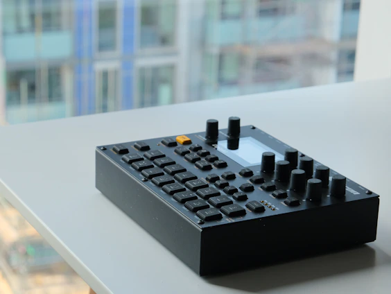 A professional radio communication device setup on a clean desk with a cityscape background.