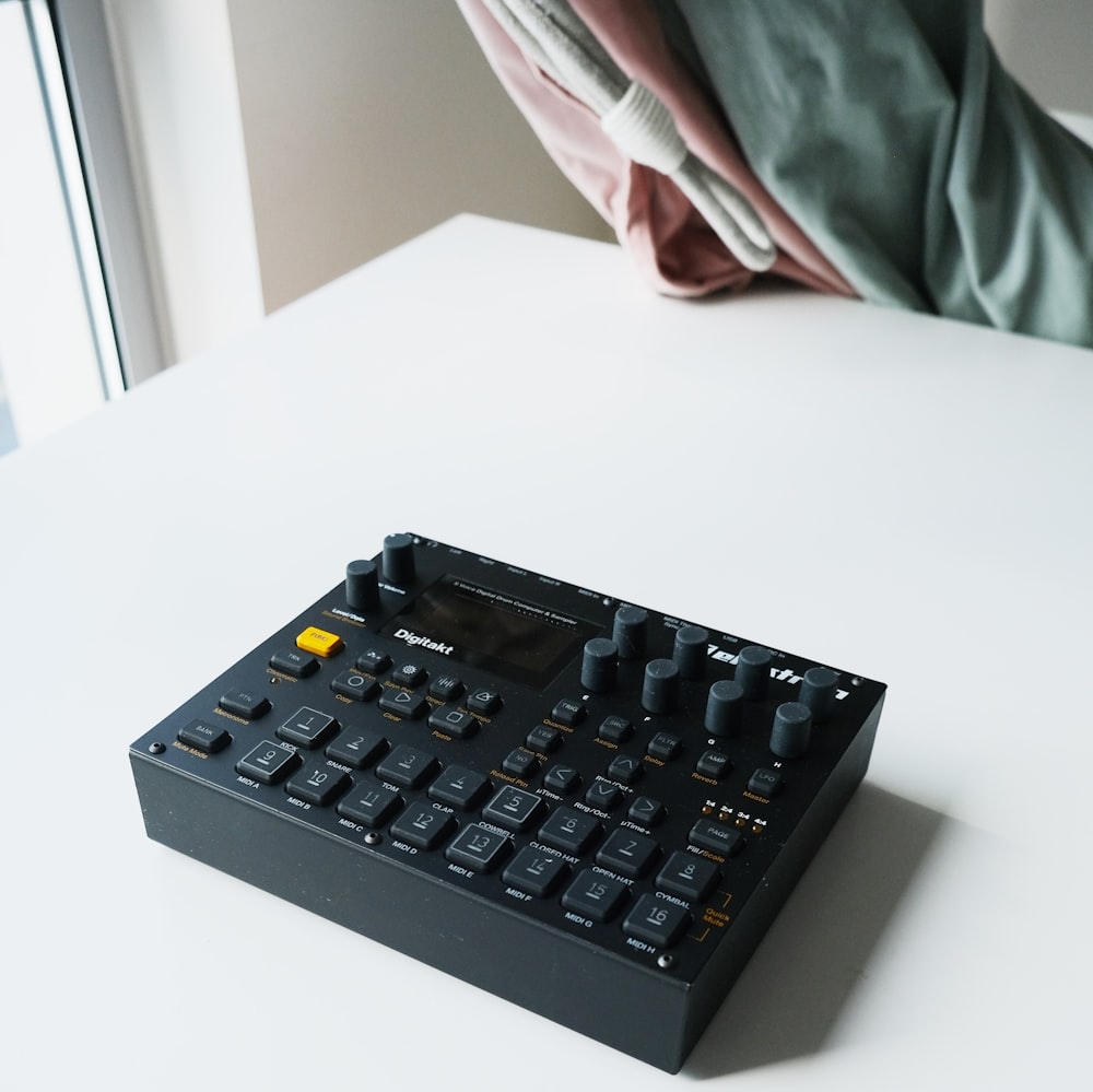 black audio mixer on white table