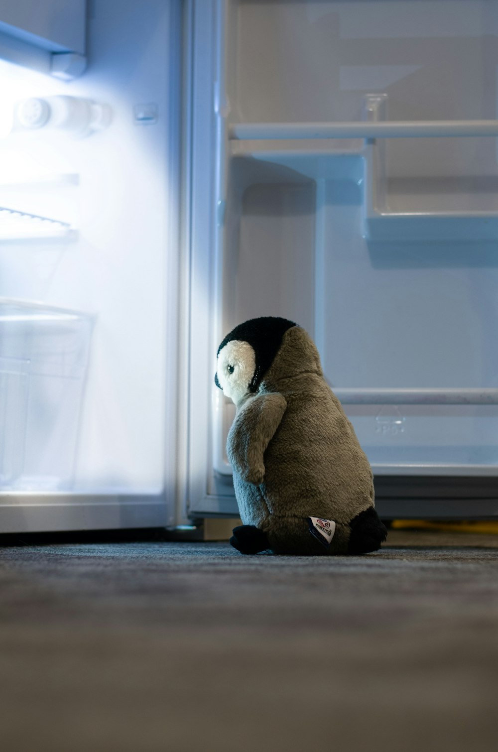 brown and white penguin plush toy