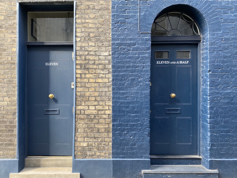 blue wooden door on brown brick building
