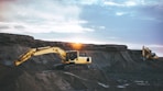 yellow and white excavator on rocky mountain during daytime