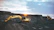 A loader machine moving earth on a rural construction project during sunset.