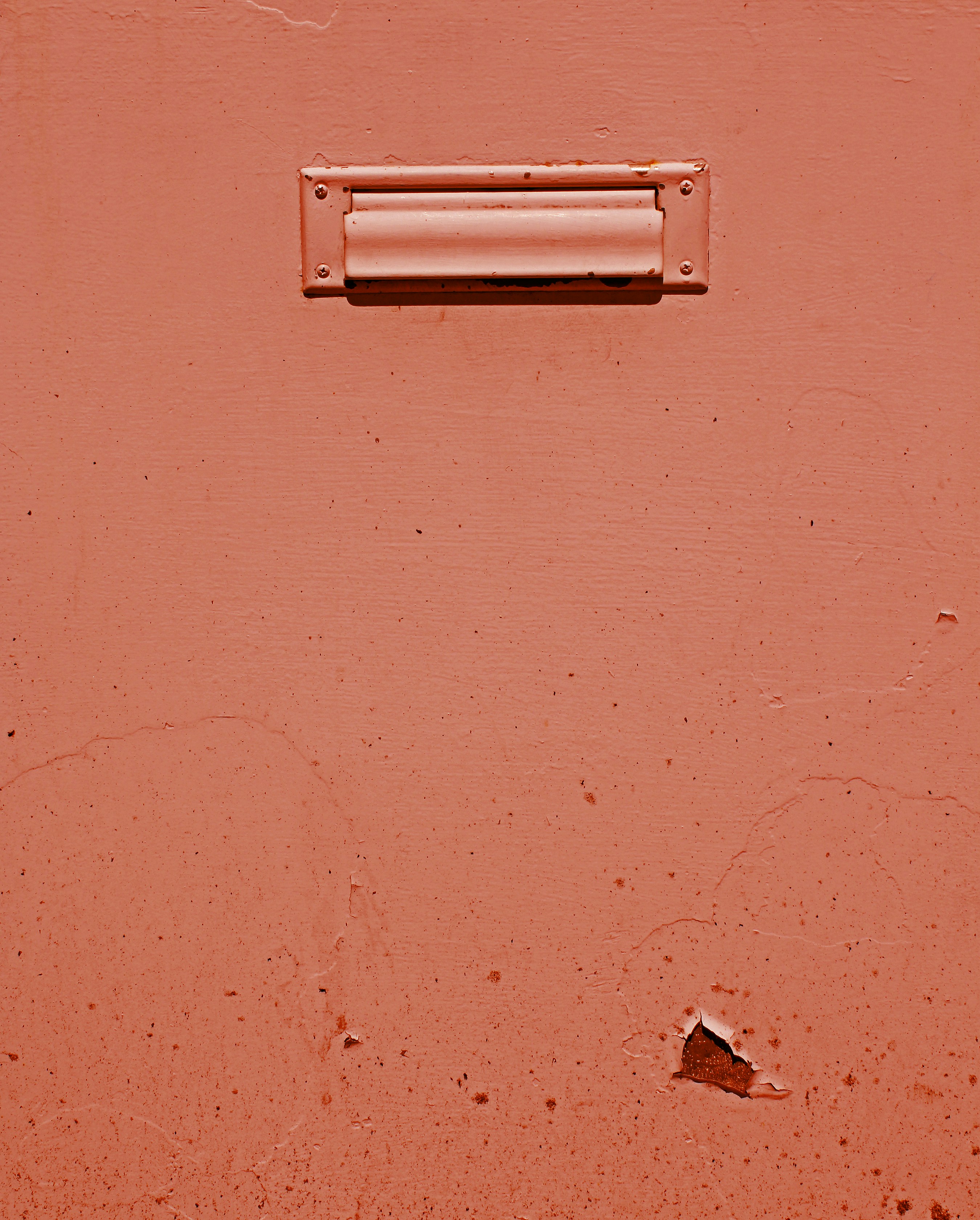 pink metal door lock on orange wall