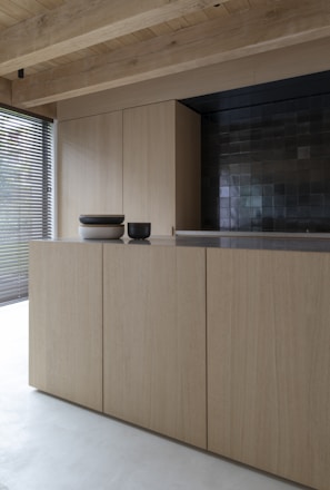 brown wooden cabinet near window