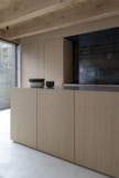 brown wooden cabinet near window