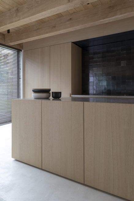 brown wooden cabinet near window