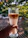 Photo of a barista happily mixing a colorful mocktail in a bright, modern cafe setting.
