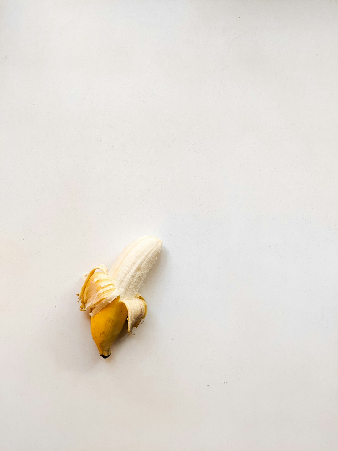 yellow banana peel on white table