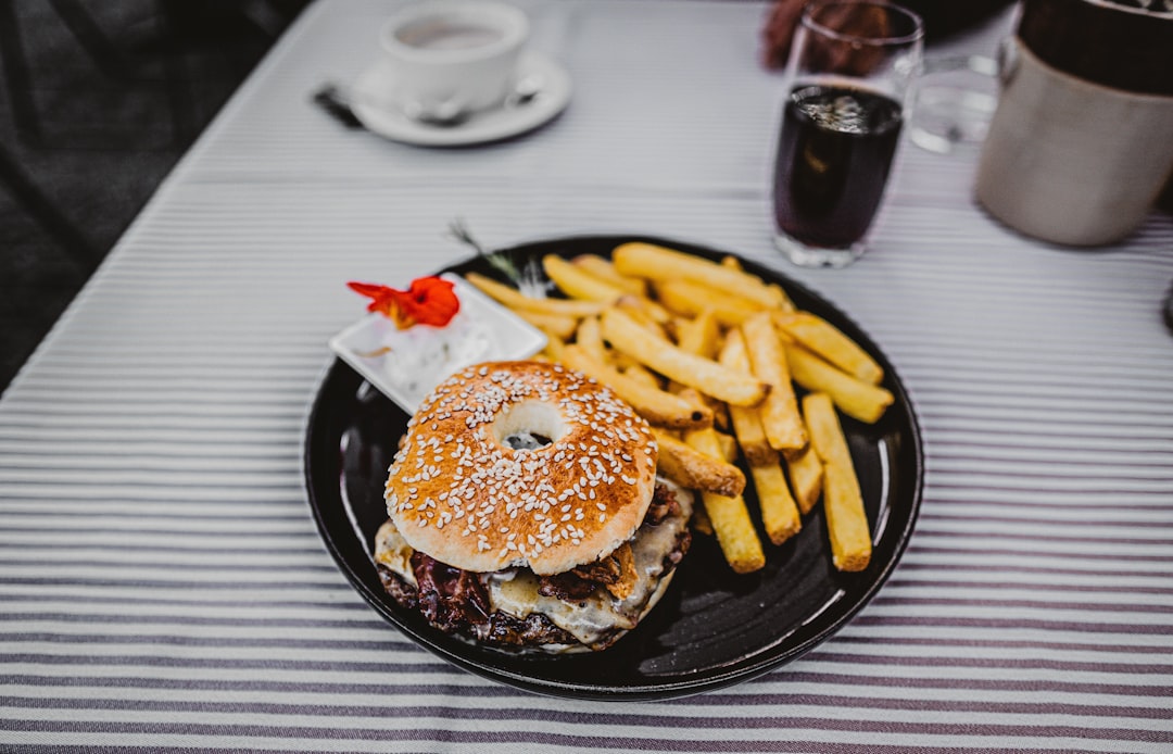 burger with fries on black plate