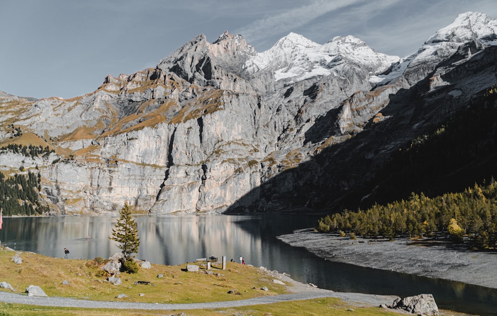 lake near snow covered mountain during daytime