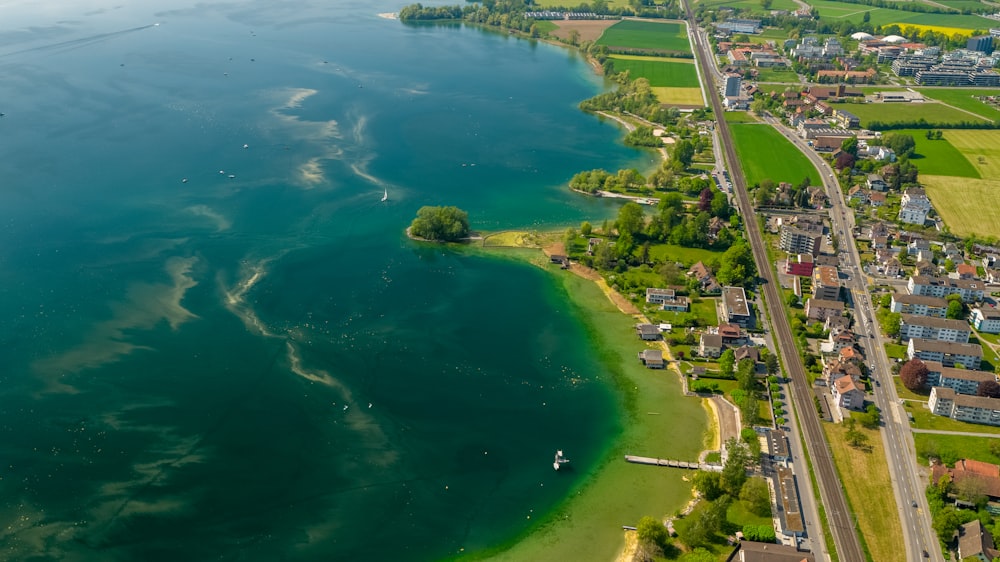 aerial view of green and brown land near body of water during daytime