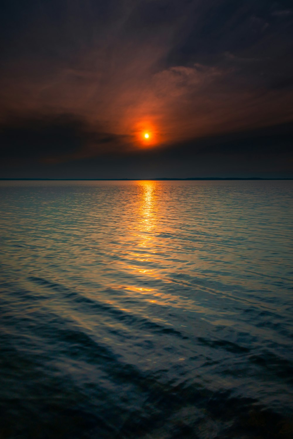 body of water during sunset