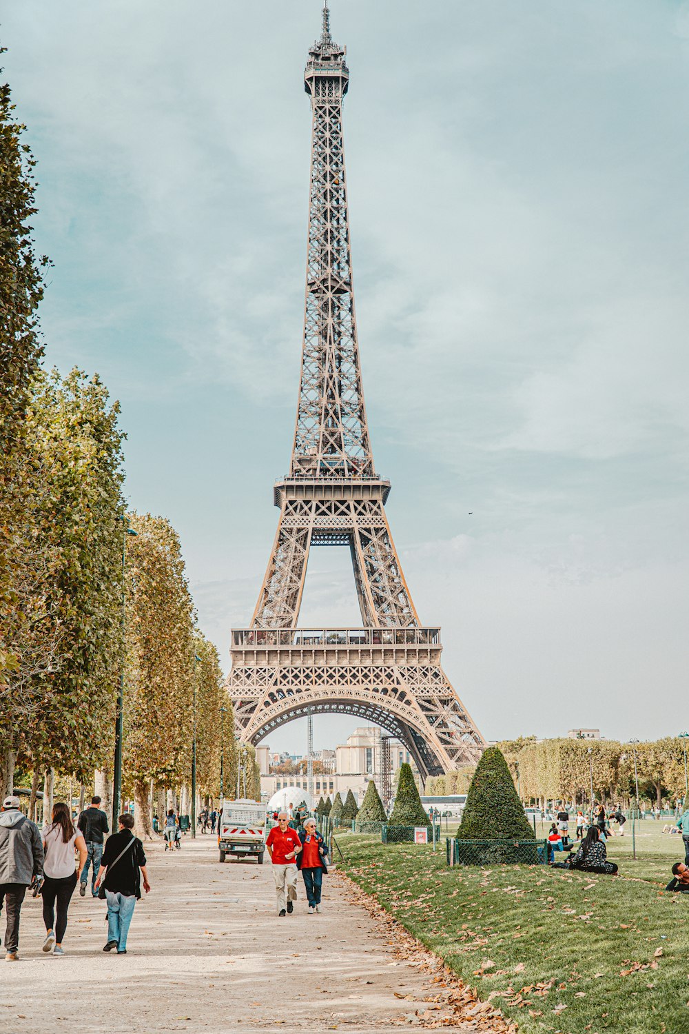 people walking on park with eiffel tower in background during daytime