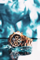 The holographic reflections on the watch dial creating energy waves in molten gold hues.