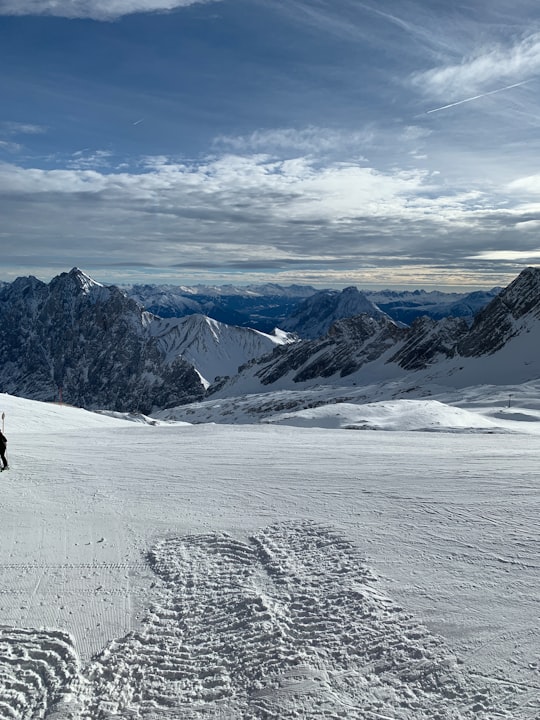person walking on snow covered mountain during daytime in Zugspitze Germany