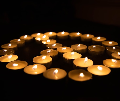 white candles on black surface