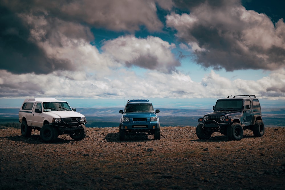 black suv on brown field under cloudy sky