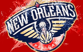 The logo for the New Orleans Pelicans basketball team, featuring a stylized pelican with outstretched wings and a basketball at its center. The background is bright red with dynamic paint splatters in white and blue.