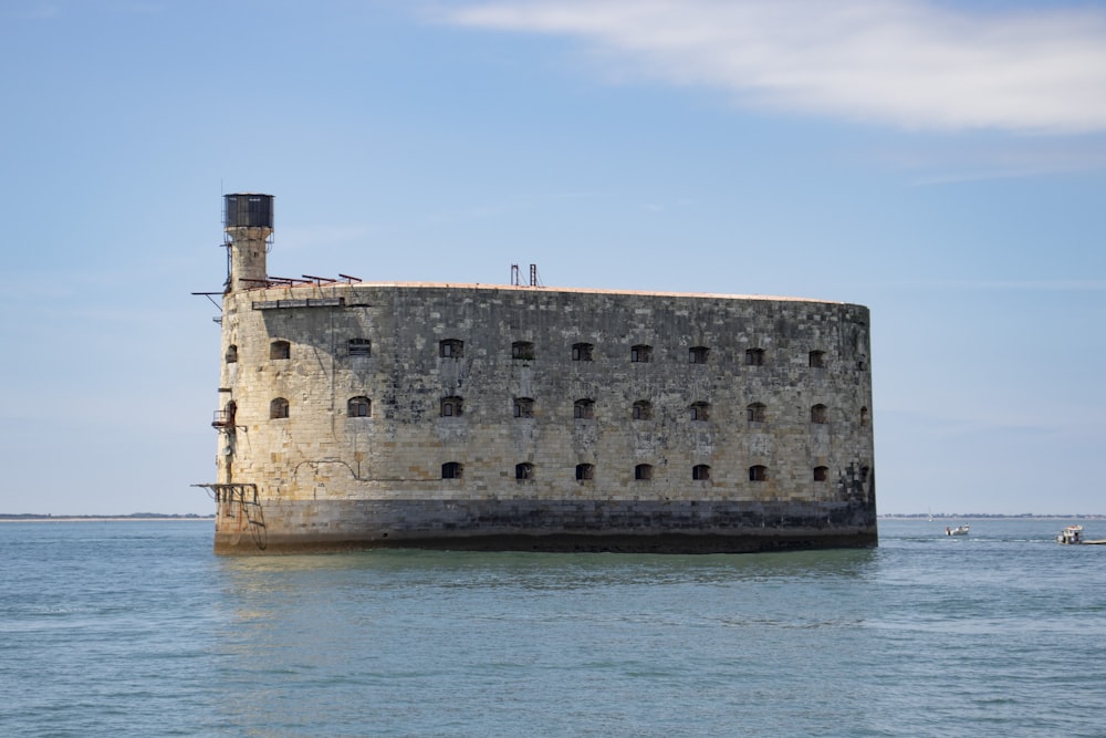 brown concrete building near body of water during daytime