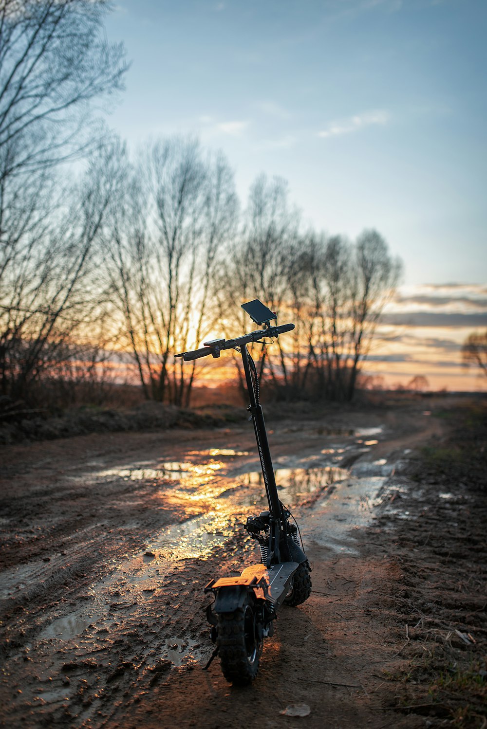 black and yellow power tool on brown dirt road during daytime