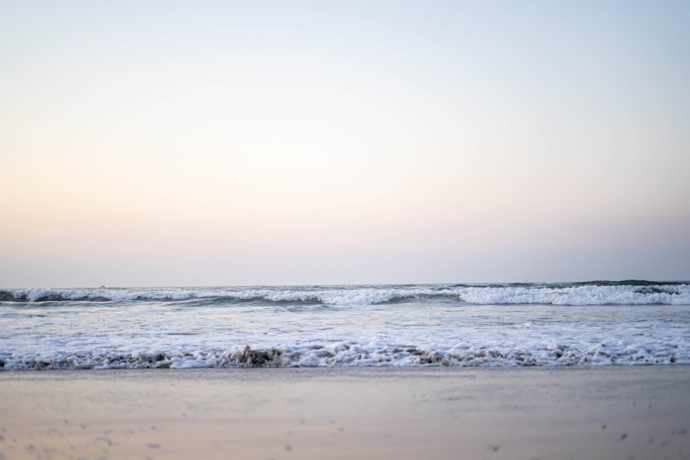 ocean waves crashing on shore during daytime