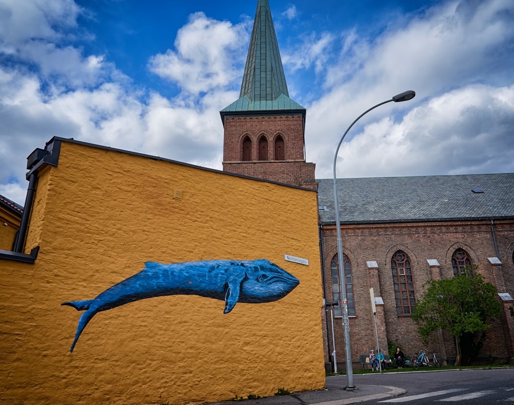 blue dragon statue near brown concrete building during daytime