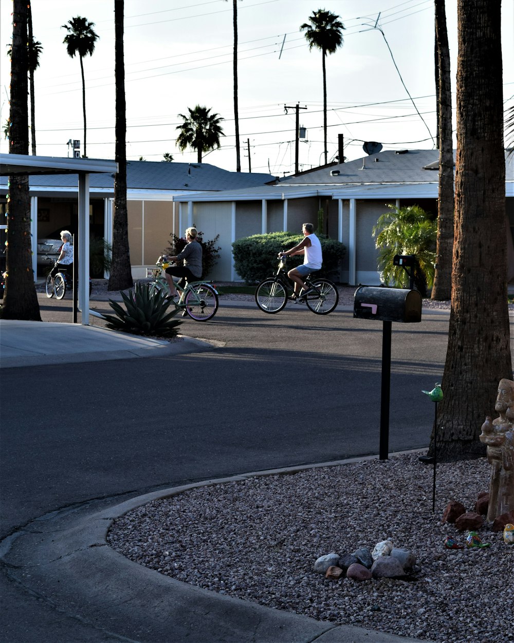 black bicycle parked beside white building during daytime