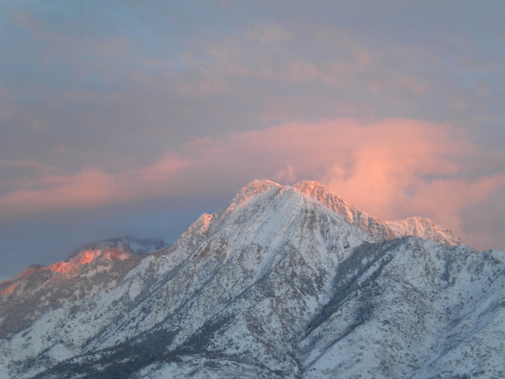 snow covered mountain under cloudy sky during daytime