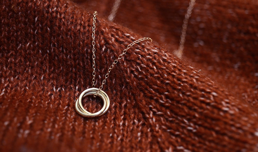 silver ring on brown textile