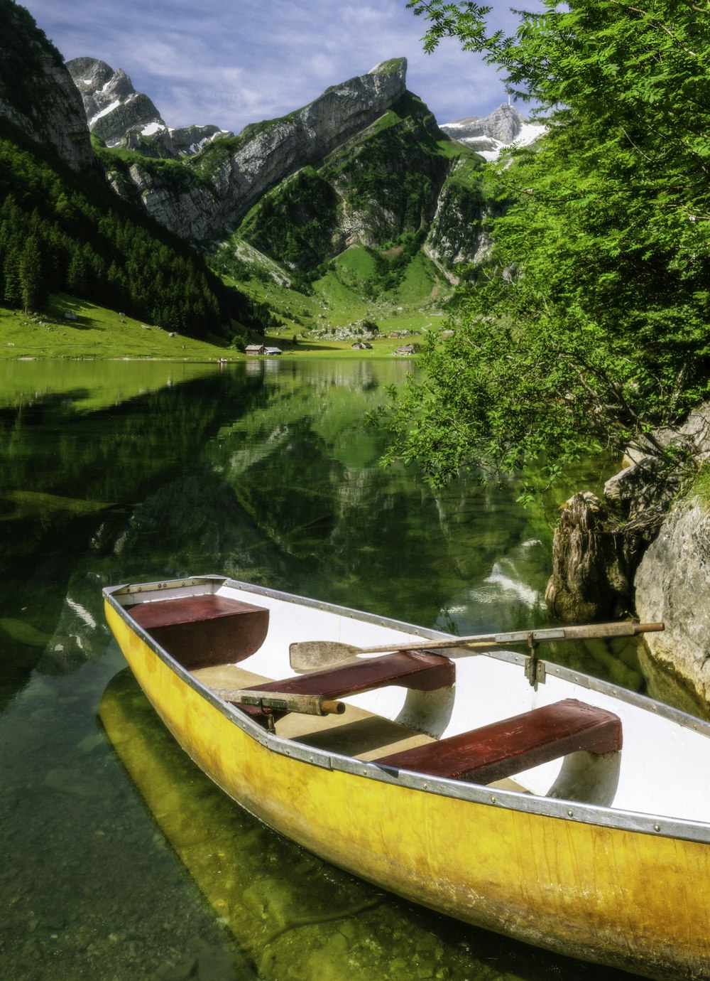 brown wooden boat on lake during daytime