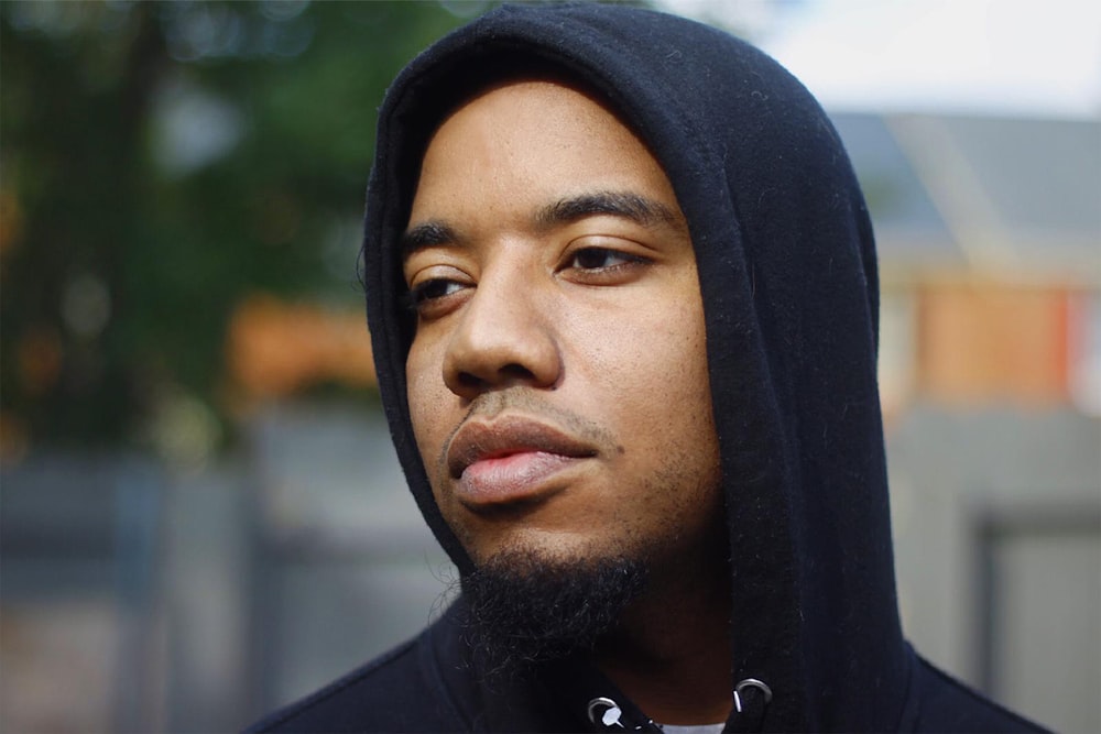 man in black hoodie wearing silver necklace