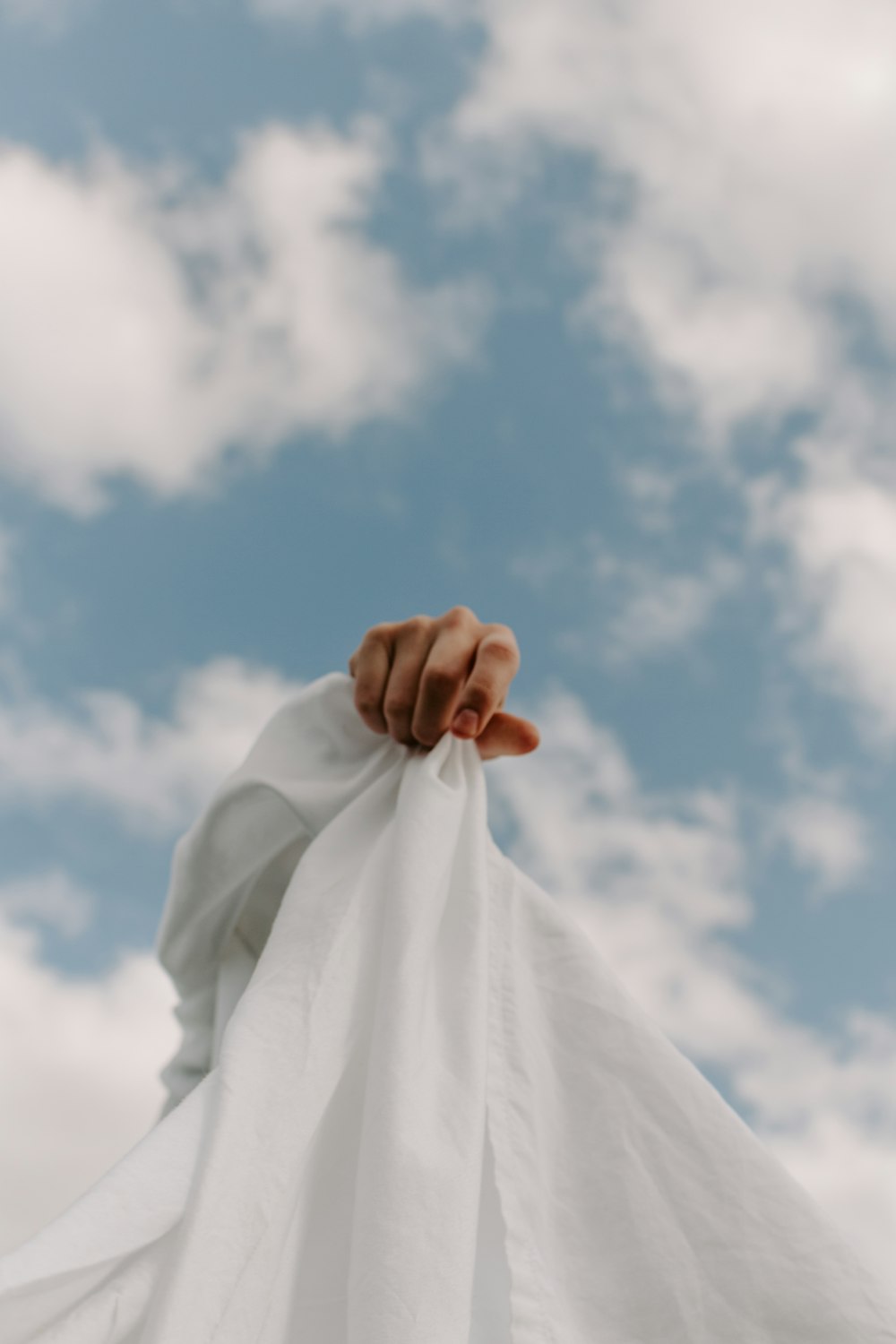 person in white dress shirt under blue sky during daytime